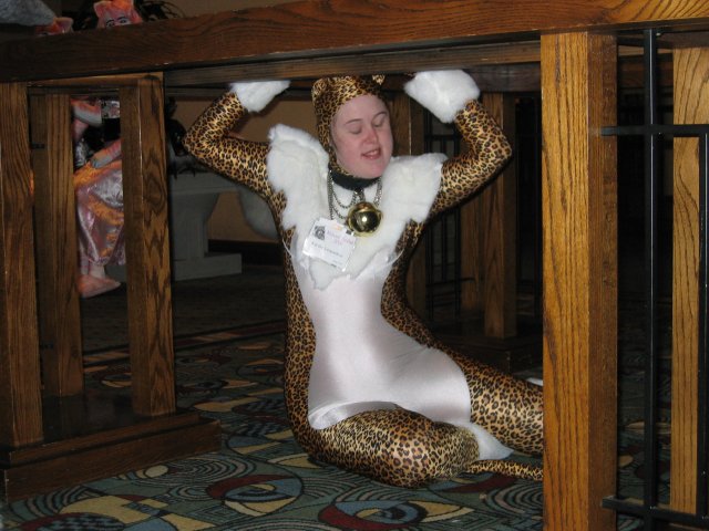 Kat the Leopardess under table